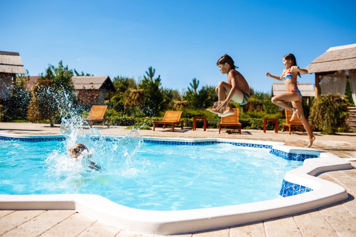 cheerful-children-rejoicing-jumping-swimming-pool